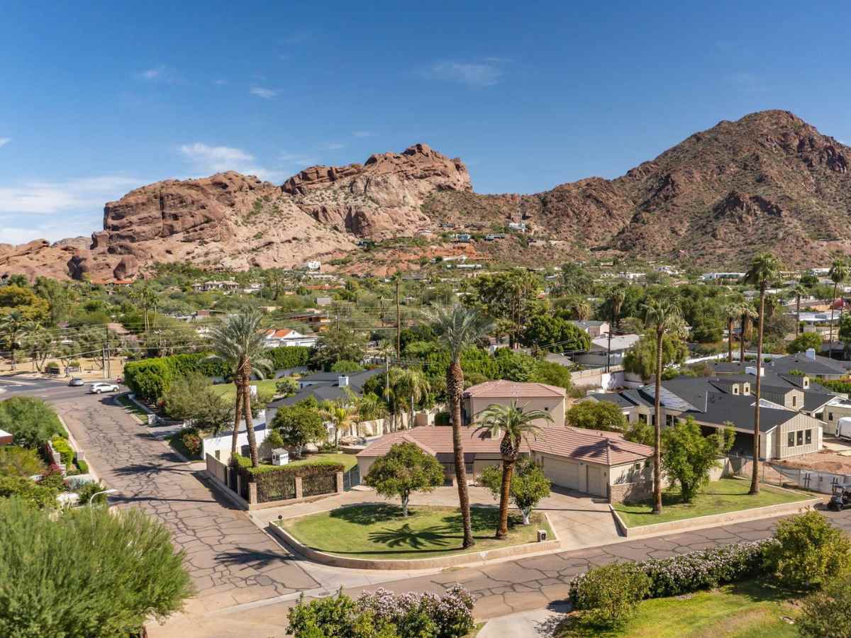 Aerial view of Arcadia a Phoenix neighborhood with houses in foreground and mountain in background for article Top 10 Popular Phoenix Neighborhoods for newcomers moving to Phoenix.