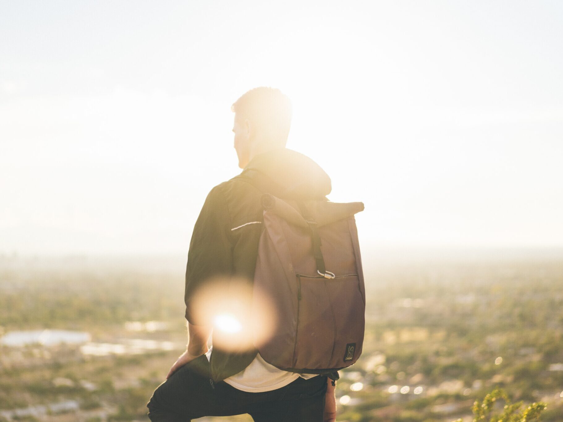 Man standing in the sun looking in the distance.