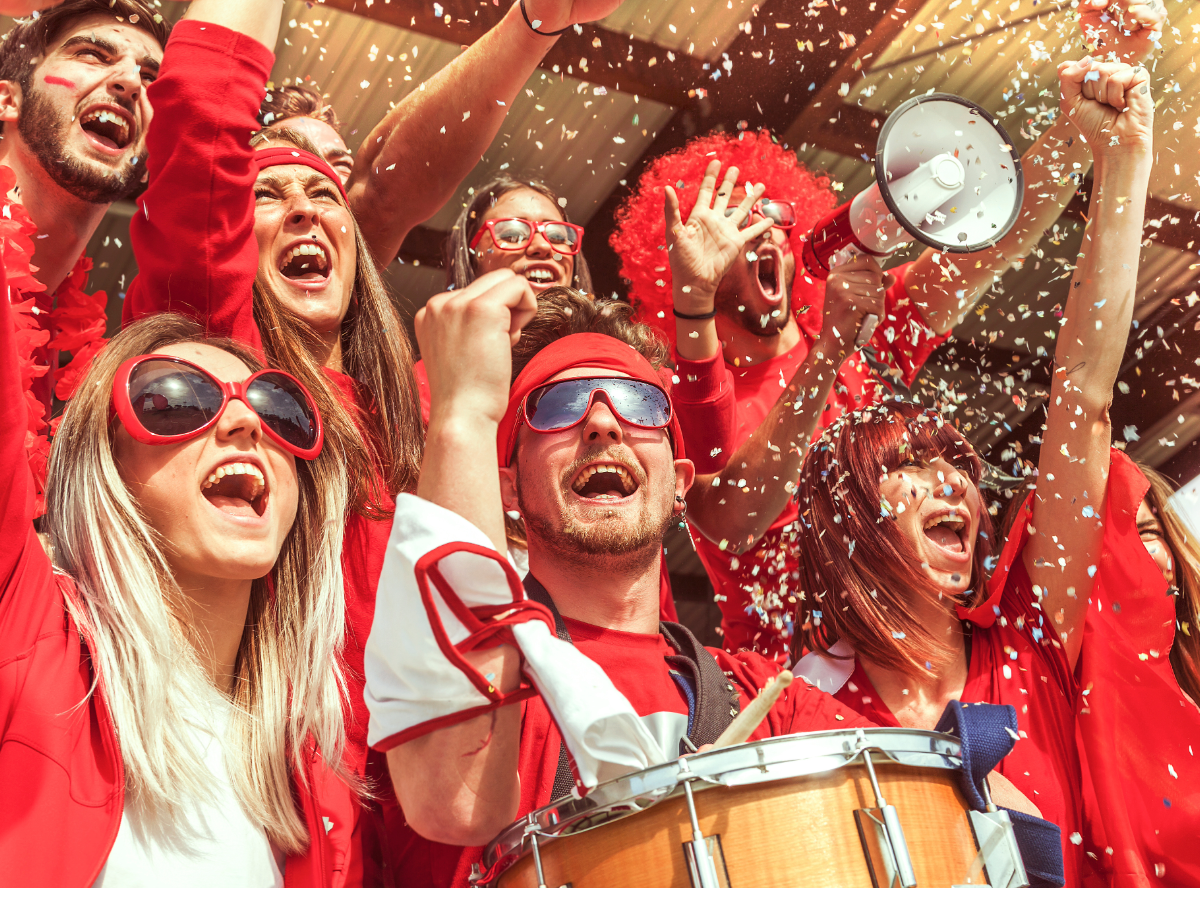 Sports fans cheering at a sporting event.