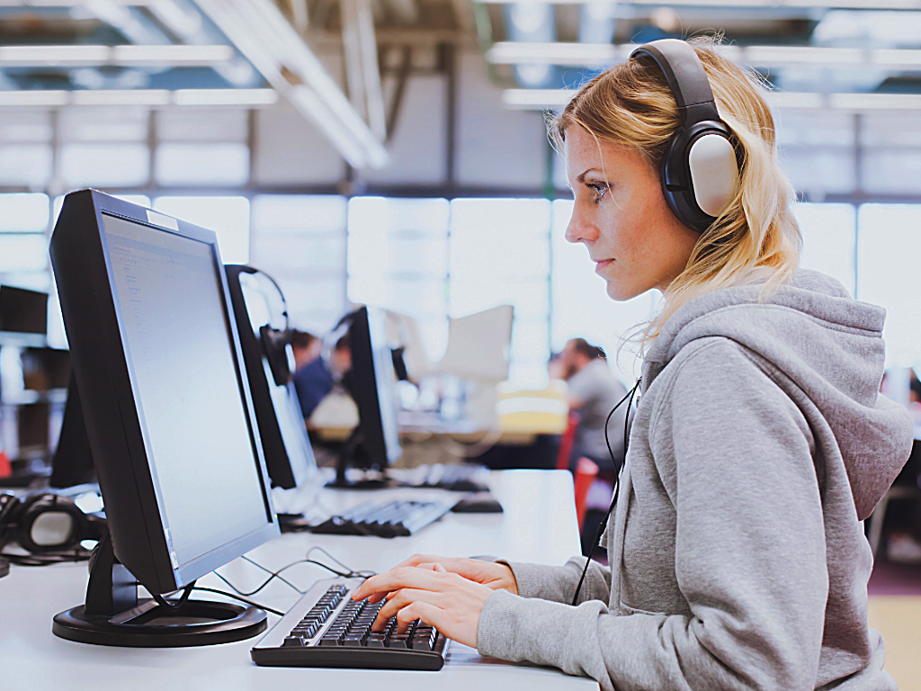 Female of a computer in a classroom learning computer skills.