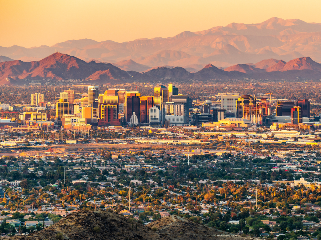 Skyline view of downtown Phoenix with mountains in the background for article on Finding Your Dream Home in Arizona for newcomers moving to Phoenix.