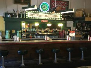 Old fashioned soda fountain shop counter with stools at MacAlpine's Diner and Soda Fountain for article 13 Quirky Things to Do in Phoenix for newcomers moving to Phoenix.