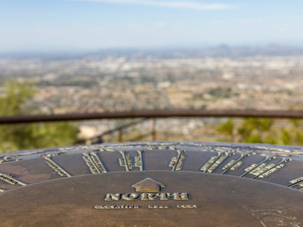 a metal object with a city in the background, North Phoenix