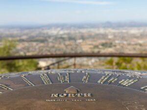 a metal object with a city in the background, North Phoenix