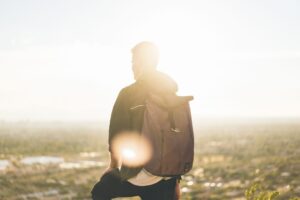 Man standing in the sun looking in the distance.